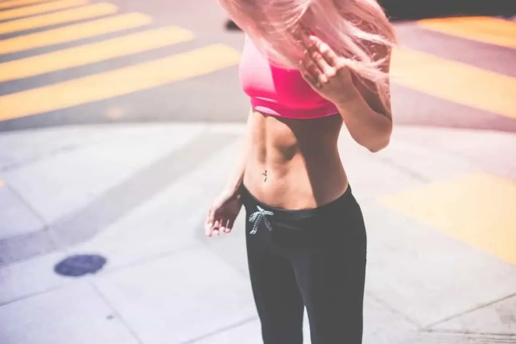 Woman with toned stomach after LA-EMS Body Sculpting Treatment Acton Green 